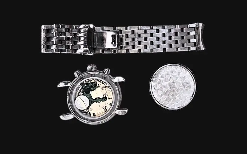 watch repair showing internal movement components and bracelet requiring professional service